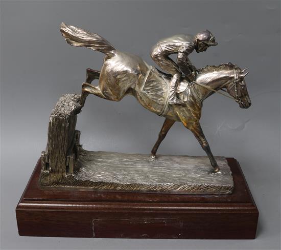 After R. Donaldson- A modern silver overlaid model of a racehorse and jockey jumping a fence, Camelot Silverware Ltd, Sheffield, 2006.